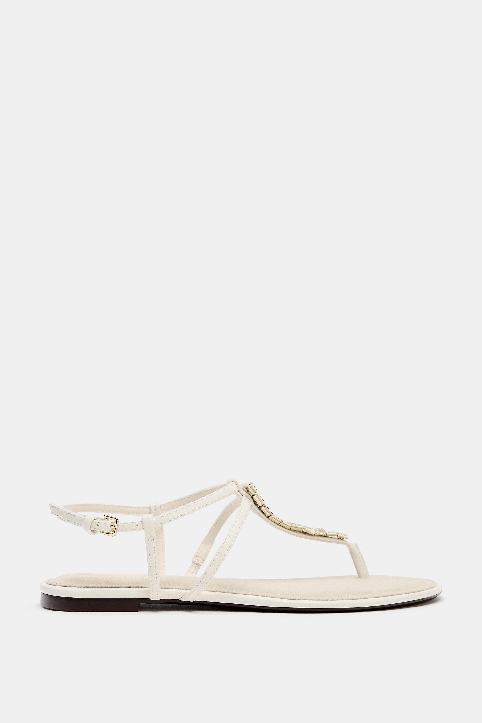 FLAT SANDALS WITH METALLIC APPLIQUES